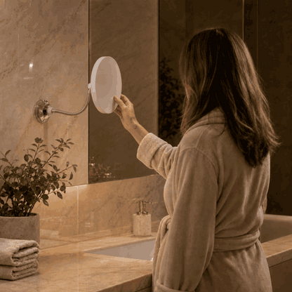 Woman switches on the LED makeup mirror in the bathroom and pulls the flexible arm closer
