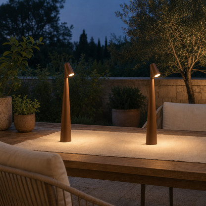 Two brown cordless LED table lamps LumiNord on a garden terrace at dusk