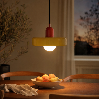 Bauhaus glass pendant light Halo with olive glass disc and red cap above a dining table