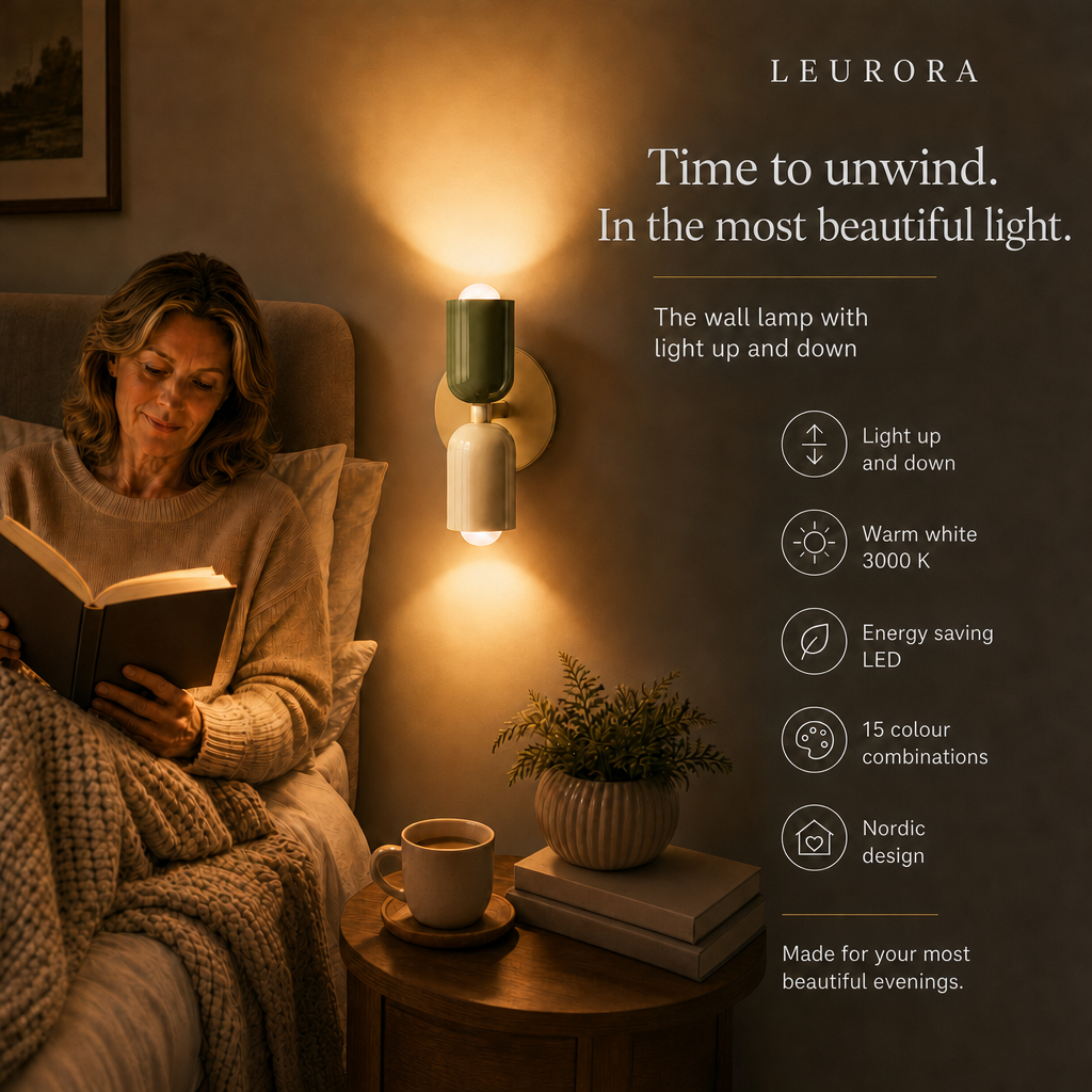 Woman reading in bed next to the Orion LED wall light with light up and down, warm white 3000 K