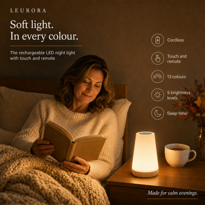 Woman reading in bed next to the LumiMood touch night light with remote, 13 colours and sleep timer