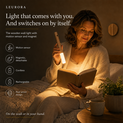 Woman reading in the light of the detachable LumiWood wooden wall light used as a handheld light